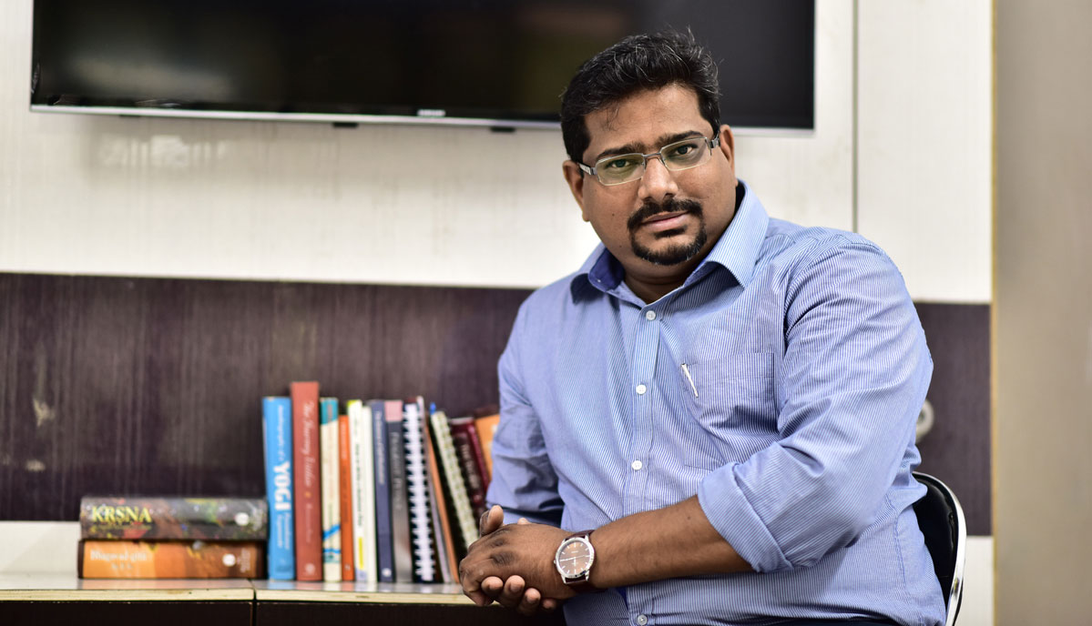 Group of young businesspeople sharing ideas in the office during a productive meeting, using colorful sticky notes on a whiteboard